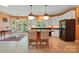 Bright eat-in kitchen featuring an island with seating, white cabinets and stainless-steel appliances at 6009 Glen Manor Dr, Charlotte, NC 28269