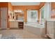Bright bathroom with soaking tub, vanity area, and tile flooring at 6009 Glen Manor Dr, Charlotte, NC 28269