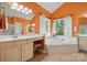 Main bathroom featuring a large soaking tub, walk-in shower, and vanity with makeup station at 6009 Glen Manor Dr, Charlotte, NC 28269