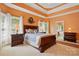 This bedroom features trey ceilings, natural light, and decorative wreath over the bed at 6009 Glen Manor Dr, Charlotte, NC 28269