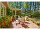 Inviting brick patio with outdoor seating, rug, and lush landscaping, perfect for relaxation and outdoor enjoyment at 6009 Glen Manor Dr, Charlotte, NC 28269