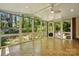Bright and airy sunroom with tile flooring and multiple large windows offering serene views of the backyard at 6009 Glen Manor Dr, Charlotte, NC 28269