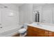 Bathroom featuring a tub with shower and vanity with storage at 626 N Graham St # 405, Charlotte, NC 28202
