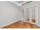 Bright bedroom features exposed ceiling and a mirrored closet at 626 N Graham St # 405, Charlotte, NC 28202