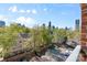 Scenic city views from a balcony overlooking a parking lot and trees at 626 N Graham St # 405, Charlotte, NC 28202