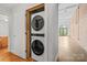 Convenient in-unit laundry featuring a stacked washer and dryer, and modern design in a well-lit space at 626 N Graham St # 405, Charlotte, NC 28202