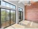 Inviting living space with a ceiling fan, large windows offering natural light, and views of the surrounding greenery at 626 N Graham St # 405, Charlotte, NC 28202