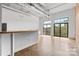 Open living area with concrete floors, large windows, and a cozy breakfast bar overlooking neighborhood views at 626 N Graham St # 405, Charlotte, NC 28202