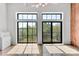 Bright living room with floor to ceiling windows and a door leading to a balcony with city views at 626 N Graham St # 405, Charlotte, NC 28202