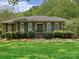 Charming brick home featuring a well-manicured lawn and lush green landscaping at 6420 Saint John Ln, Charlotte, NC 28210