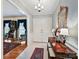 Inviting foyer with a decorative mirror, elegant chandelier, and pristine tile flooring at 6420 Saint John Ln, Charlotte, NC 28210