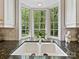 Kitchen sink with a bay window offering views of the lush outdoors at 6420 Saint John Ln, Charlotte, NC 28210