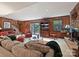 Inviting living room featuring a stone fireplace, piano, and sliding glass doors to the backyard at 6420 Saint John Ln, Charlotte, NC 28210