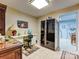 Functional home office setup with a desk, office chair, unique refrigerator, and ample storage at 6420 Saint John Ln, Charlotte, NC 28210