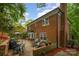 Brick home exterior showcasing patio, manicured lawn, and lush greenery at 6634 Rocky Falls Rd, Charlotte, NC 28211