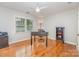 Comfortable bedroom with hardwood floors, a ceiling fan, a desk and bookcase at 6634 Rocky Falls Rd, Charlotte, NC 28211