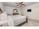Spacious bedroom featuring a ceiling fan, two closets, and hardwood furniture at 6634 Rocky Falls Rd, Charlotte, NC 28211