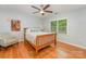 This bedroom features hard wood floors, a modern ceiling fan and lots of natural light at 6634 Rocky Falls Rd, Charlotte, NC 28211