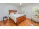 Comfortable bedroom with hardwood floors, a ceiling fan, and ample natural light at 6634 Rocky Falls Rd, Charlotte, NC 28211