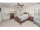 Bright bedroom with a ceiling fan, hardwood furniture, and white walls at 6634 Rocky Falls Rd, Charlotte, NC 28211