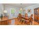 Bright dining room featuring hardwood floors, a large window, and traditional furnishings at 6634 Rocky Falls Rd, Charlotte, NC 28211