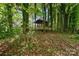 Secluded backyard gazebo surrounded by mature trees and greenery at 6634 Rocky Falls Rd, Charlotte, NC 28211
