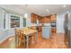 Eat-in kitchen with wood cabinets, stainless steel appliances, and a large bay window at 6634 Rocky Falls Rd, Charlotte, NC 28211
