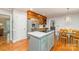 Modern kitchen with a center island, stainless steel appliances, and hardwood floors at 6634 Rocky Falls Rd, Charlotte, NC 28211