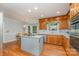 Charming kitchen featuring wood cabinets, stainless steel appliances, and a center island cooktop at 6634 Rocky Falls Rd, Charlotte, NC 28211