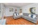 Comfortable living room area with hardwood floors and a sectional sofa at 6634 Rocky Falls Rd, Charlotte, NC 28211