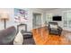 Comfortable living room with hardwood floors, wainscoting, and ample natural light at 6634 Rocky Falls Rd, Charlotte, NC 28211
