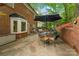 This patio features a dining set with 4 chairs, extra seating, a grill and privacy wall at 6634 Rocky Falls Rd, Charlotte, NC 28211