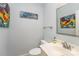 Well-lit powder room with white vanity, modern fixtures, and tasteful decor, providing convenience for guests at 6634 Rocky Falls Rd, Charlotte, NC 28211