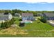 Aerial view of a backyard with a pool, fire pit, and trampoline, ideal for Gathering fun and outdoor gatherings at 708 Brookmeade Dr, Waxhaw, NC 28173