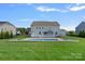 Large backyard featuring a swimming pool, deck, and green grass at 708 Brookmeade Dr, Waxhaw, NC 28173