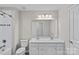 White bathroom vanity with double sinks and walk-in shower at 708 Brookmeade Dr, Waxhaw, NC 28173