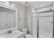 Bathroom with glass shower, tiled walls, vanity, and brushed nickel fixtures at 708 Brookmeade Dr, Waxhaw, NC 28173