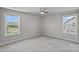Bright bedroom offering ample natural light through two windows and a ceiling fan for added comfort at 708 Brookmeade Dr, Waxhaw, NC 28173