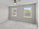 Light-filled bedroom featuring neutral walls and two windows for natural light with scenic outdoor views at 708 Brookmeade Dr, Waxhaw, NC 28173