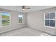 Bright bedroom with three windows and neutral carpet and paint at 708 Brookmeade Dr, Waxhaw, NC 28173