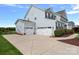 Spacious home featuring a three-car garage and a neatly paved driveway, complementing the landscaped surroundings at 708 Brookmeade Dr, Waxhaw, NC 28173