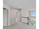 Bright upstairs hallway features neutral walls and plush carpeting leading to other rooms in the home at 708 Brookmeade Dr, Waxhaw, NC 28173