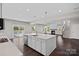 Bright, open kitchen features a large island with white cabinetry, stainless appliances, and hardwood flooring at 708 Brookmeade Dr, Waxhaw, NC 28173