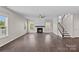 Open living room featuring a modern fireplace and lots of natural light at 708 Brookmeade Dr, Waxhaw, NC 28173