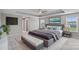 Beautiful main bedroom with tray ceiling, ceiling fan, large bed, bench, and windows for natural light at 708 Brookmeade Dr, Waxhaw, NC 28173