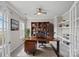 Cozy home office with built-in shelving and a large wooden desk, perfect for remote work at 708 Brookmeade Dr, Waxhaw, NC 28173