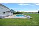 Swimming pool area featuring lovely landscaping, a grassy lawn and deck at 708 Brookmeade Dr, Waxhaw, NC 28173
