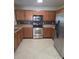 Well-lit kitchen featuring stainless steel appliances and wood cabinets at 7113 Sycamore Grove Ct, Charlotte, NC 28227