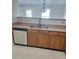 Kitchen featuring a stainless steel sink, dishwasher and wood cabinets at 7113 Sycamore Grove Ct, Charlotte, NC 28227