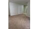 Spacious living room with plush carpet flooring and neutral walls at 7113 Sycamore Grove Ct, Charlotte, NC 28227